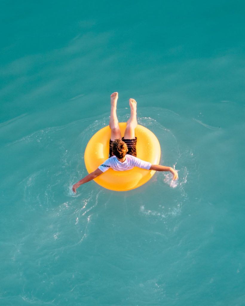 Boy enjoying the ocean in a yellow floatie