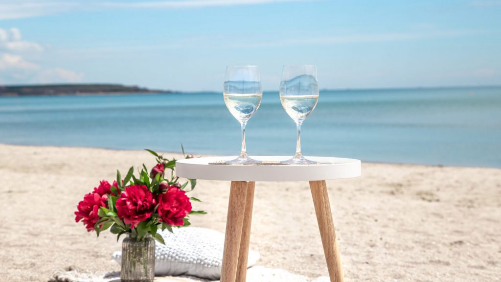 Romantic roses and wine set up on a beautiful beach