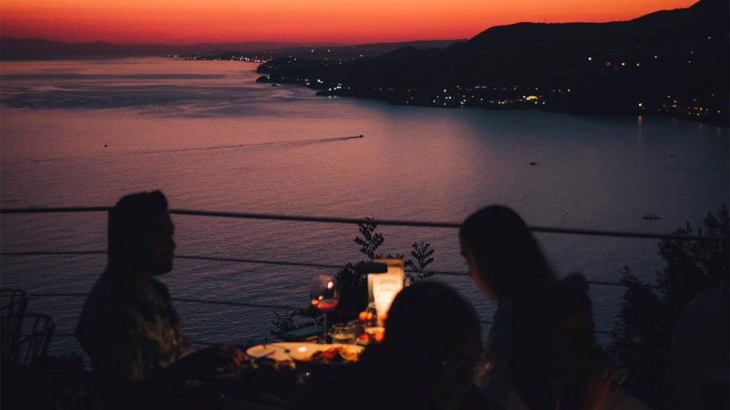 Romantic couple's dinner overlooking a beach at sunset