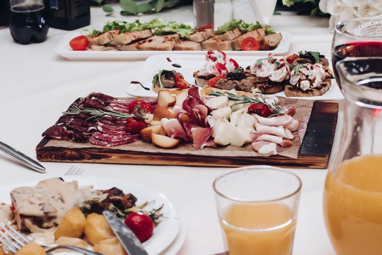 Charcuterie board and appetizers and drinks on table