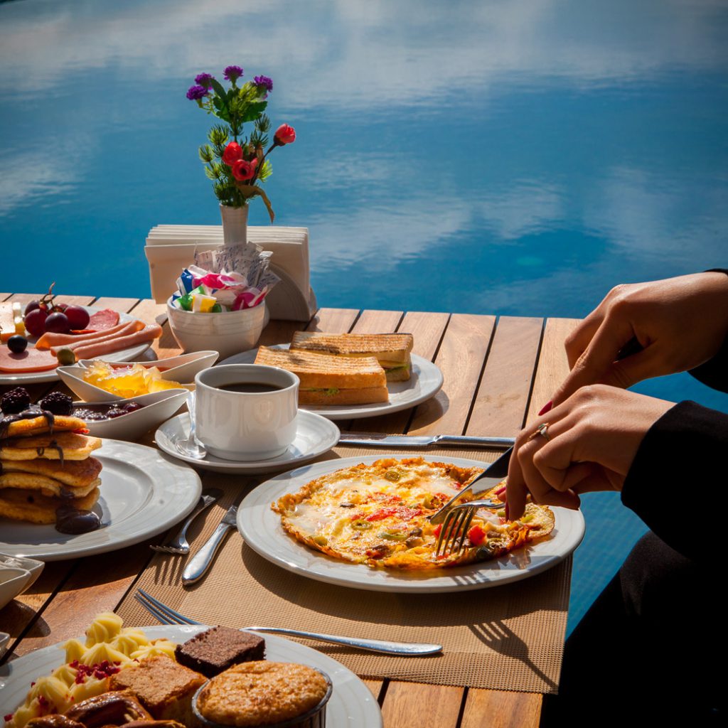 Private chef breakfast served at a waterside table